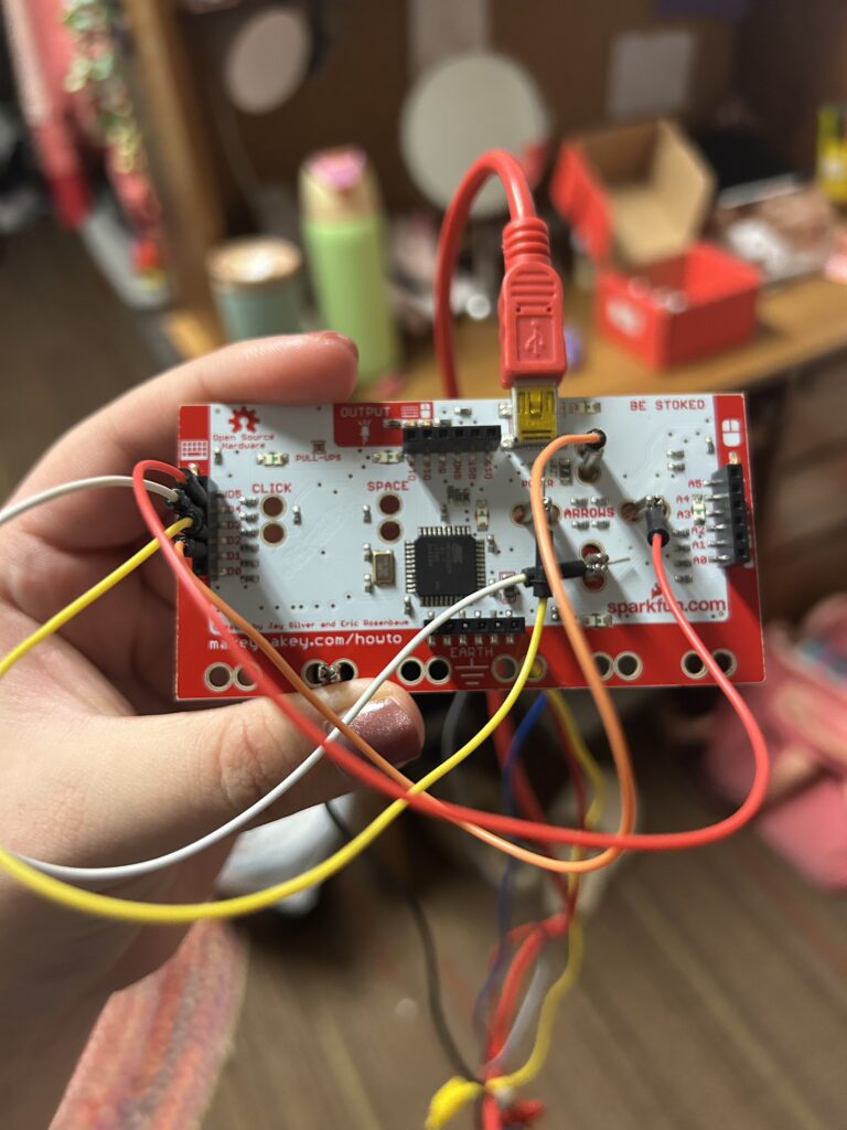 This image shows the backside of the MakeyMakey device with wires connected throughout, which I had placed in order to assist me in my hack.